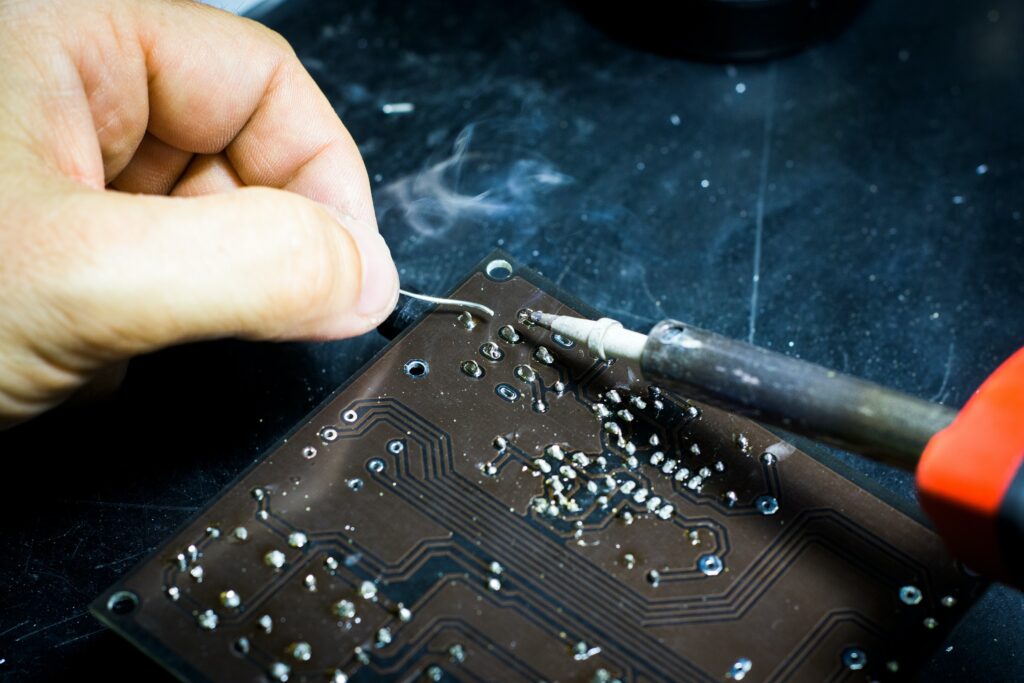 Commercial catering equipment technician repairing a PCB circuit