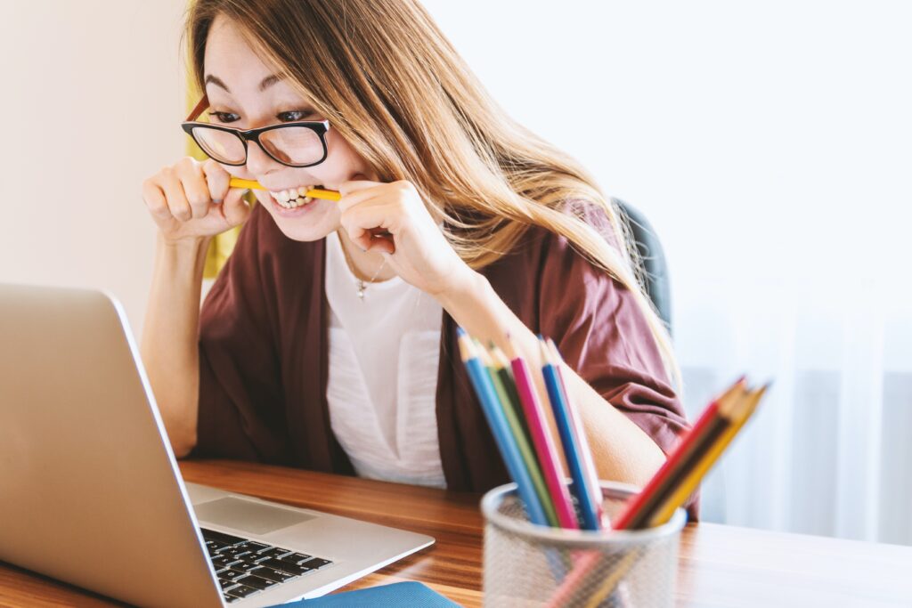 Woman looking at computer stressfully.