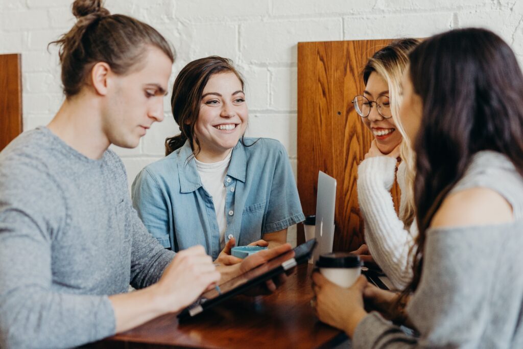 A group of young people standing in a circle smiling