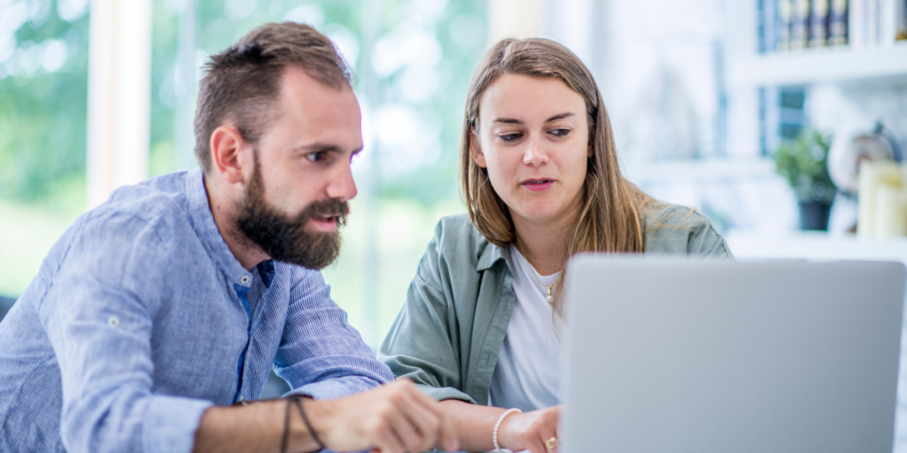 A picture of an apprentice and their employer at computer