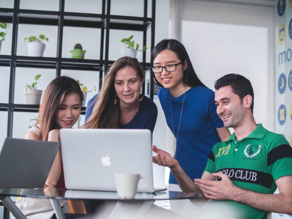 A group of apprentices looking at a laptop