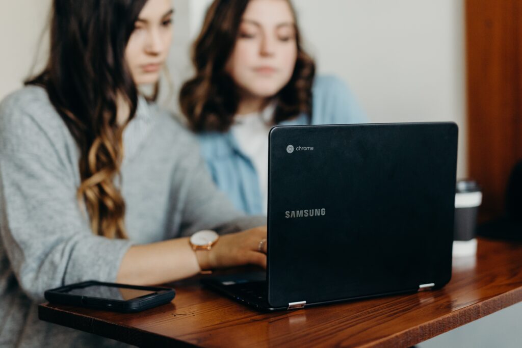 Two Digital Marketing apprentices working on a laptop. 